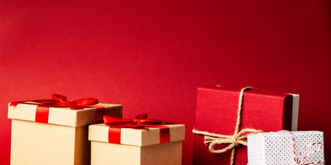 Holiday gifts against a red background