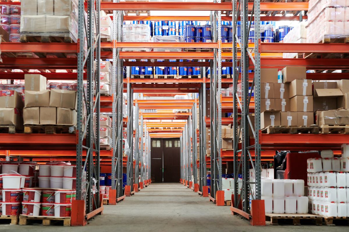 Aisleway in a warehouse showing all of the racks and products from floor to ceiling.