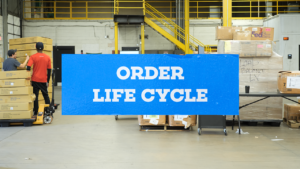 Photo of warehouse with title 'Order Life Cycle'
